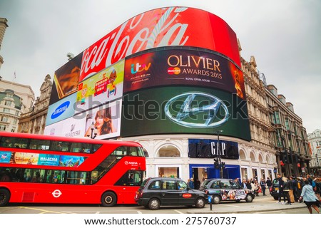 LONDON - APRIL 13: Piccadilly Circus junction crowded by people on April 13, 2015 in London, UK. It\'s a road junction and public space of London\'s West End in the City of Westminster, built in 1819.