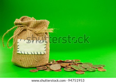 Sack full of coins over green background