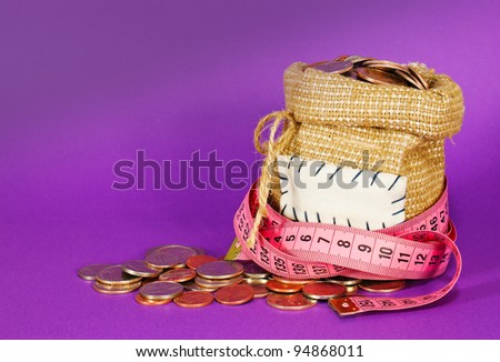 Sack full of coins over purple background