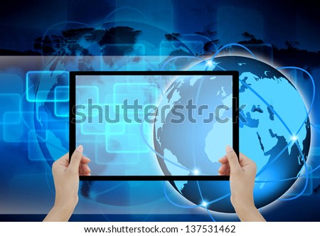holding tablet computer in his hand on abstract the world technology