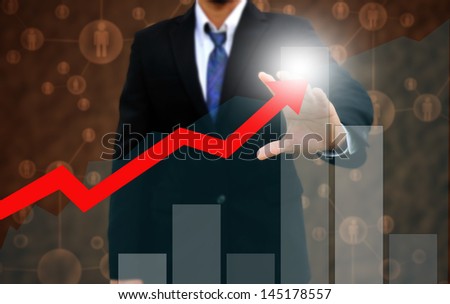 Businessman touching a rising arrow . business growth Concept .on Grunge background