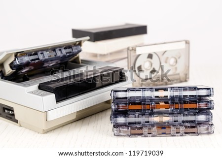 Analog cassette tapes shown together with cassette player.