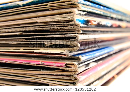 Stack of old vinyl records in traditional and colorful cardboard covers