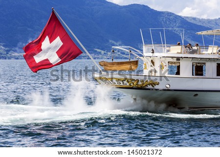 MONTREUX - MAY 30: Stern with flag of La Suisse vessel built in 1910, belongs to founded in 1873 Belle Epoque steamers fleet, departs from the port in Montreux in Switzerland on May 30, 2013