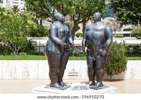 MONTE CARLO, MONACO - MAY 12, 2014: Bronze sculpture of Adam and Eve (1981) by Colombian figurative artist and sculptor Fernando Botero, located in gardens behind the Casino and Opera House