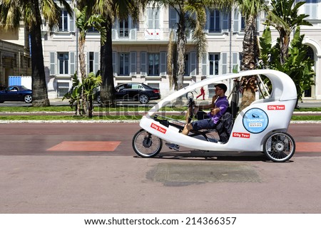 NICE, FRANCE - MAY 13, 2014: The Cyclotour, well-liked by tourists, three wheels vehicle driven by young drivers called Cyclonautes, an idea to take a city tour in environmentally friendly way