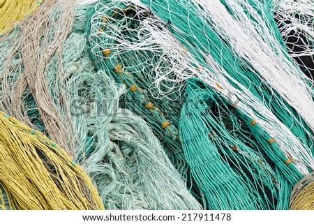 Fishing varicolored nets creates background of ropes and knots