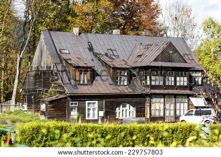 ZAKOPANE, POLAND - OCTOBER 16, 2014: Wooden Villa, with the characteristics of the local architectural monument but nowadays capable of considerable devastation, probably built in the 90s 19th century