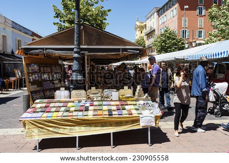 NICE, FRANCE - MAY 24, 2014: Cours Saleya, most famous City Market, offers cosmetic products, herbs, spices and various gifts, flowers also antiques and other products