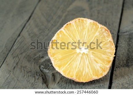 The Dried lemon shown on wooden background