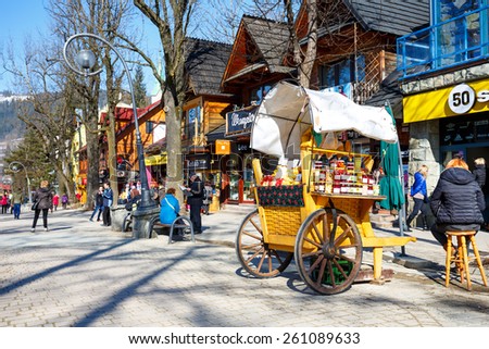 ZAKOPANE, POLAND - MARCH 09, 2015: Sales of Oscypek cheeses and other regional food products at  Krupowki street, since February 02, 2007 oscypek is Polish regional product protected by EU law