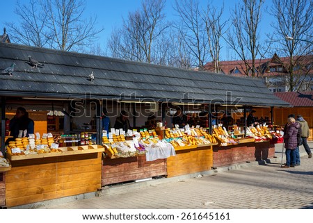 ZAKOPANE, POLAND - MARCH 10, 2015: Regional food products at the largest marketplace in the city, among other offers there is oscypek Polish regional product protected by EU law