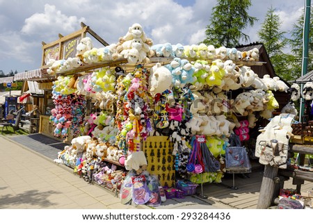 ZAKOPANE, POLAND - JUNE 12, 2015: Various souvenirs offered for sale, the stand located along the famous pedestrian street, among other offers stylized stuffed toys