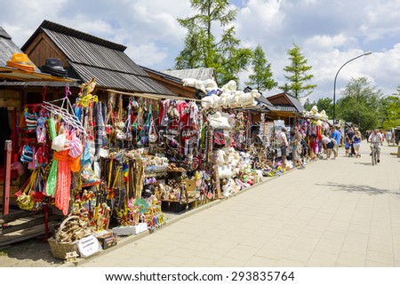 ZAKOPANE, POLAND - JUNE 12, 2015: Various souvenirs offered for sale, the stands located along the famous pedestrian street, among other offers stylized gifts and many small goods