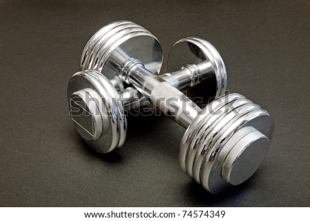 hand weights made of chromed metal on a black background