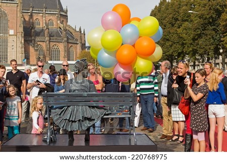 Arnhem, Netherlands - September 28, 2014: Girl with balloons on chair during the world championships living statues in Arnhem