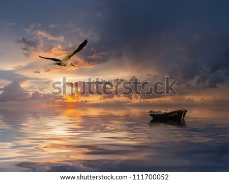 Beautiful landscape with lonely boat and birds against a sunset, majestic clouds in the sky
