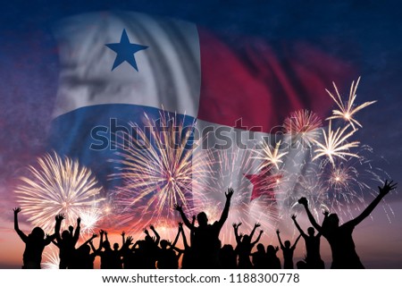 Happy people are looking holiday fireworks with flag of Panama in sky, independence day
