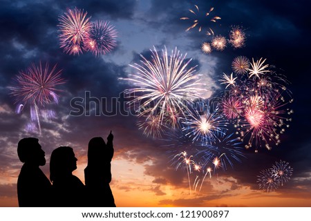 The Happy Family Looks Beautiful Colorful Holiday Fireworks In The Evening Sky With Majestic Clouds, Long Exposure