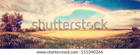 Vintage Panorama Of A Big Wheat Field With Clouds And Rainbow In The Sky