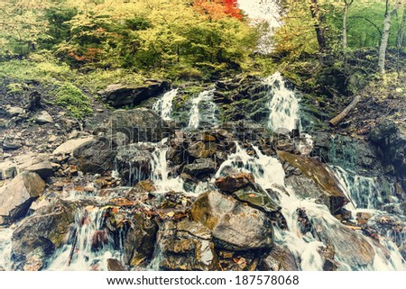 Waterfall in the mountains, autumn vintage landscape