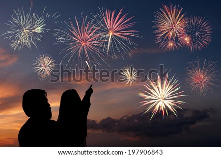 Happy father and daughter looks fireworks