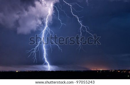 Big lightning in the stormy sky over a city
