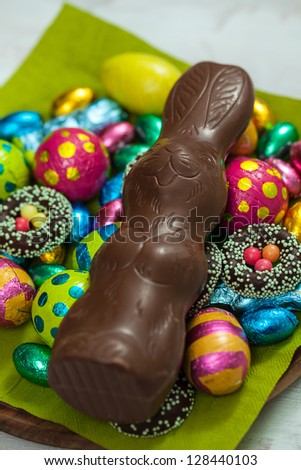 Easter sweets on plate; chocolate bunny, cakes, biscuits and eggs;