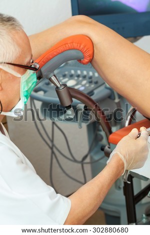 Senior doctor performing gynecological examination