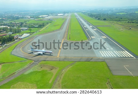 SAN JOSE, COSTA RICA - May 10: Aerial view of runway at Juan Santamaria International Airport on May 10, 2014 in San Jose, the capital of Costa Rica. This airport is the primary airport in the country