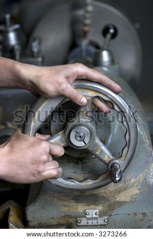 Hands of the operator of heavy industrial machine