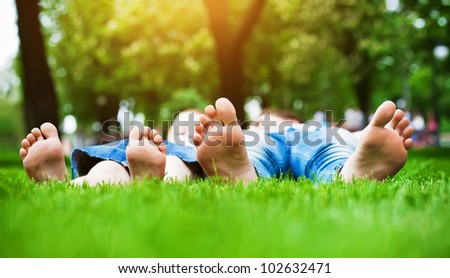 Children's feet  on grass. Family picnic in  park