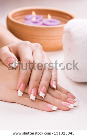 female hands with aromatic candles and towel