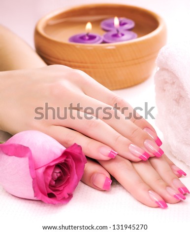 female hands with fragrant rose petals and towel