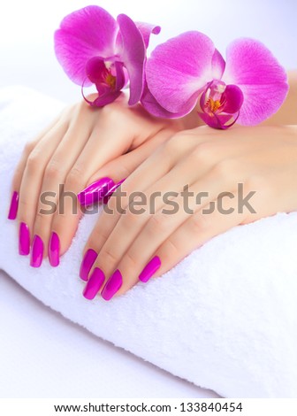 female hands with fragrant orchid and towel