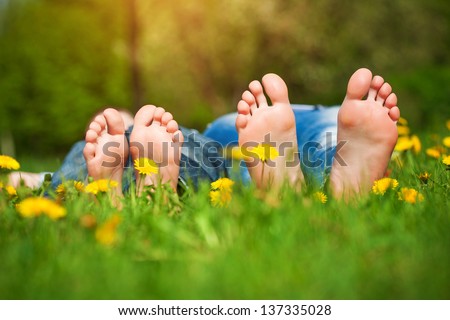 Children\'s feet  on grass. Family picnic in  park