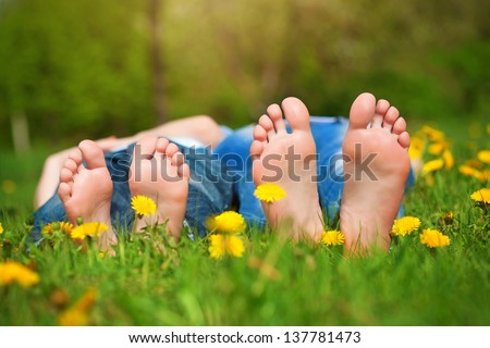 Children\'S Feet On Grass. Family Picnic In Park