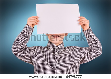 cute boy with white sheet of paper
