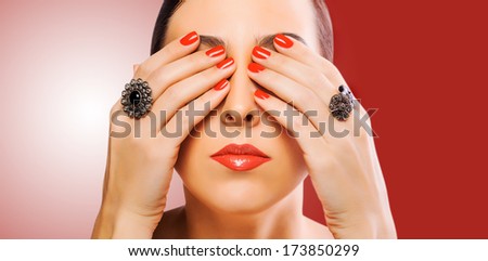 face and beautiful red manicure