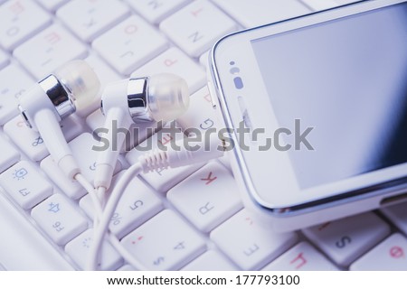 smartphone with headphones on the keypad