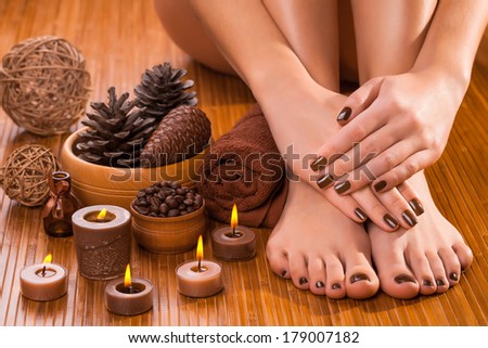 beautiful brown manicure and pedicure on the white