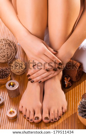 beautiful brown manicure and pedicure on the bamboo