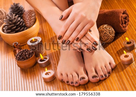beautiful brown manicure and pedicure on the bamboo