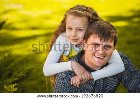 father and daughter are playing in the park