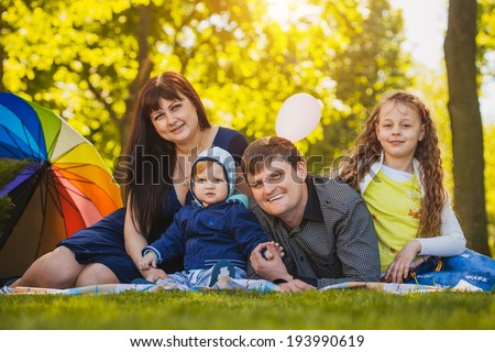Happy family are plaing in the summer park