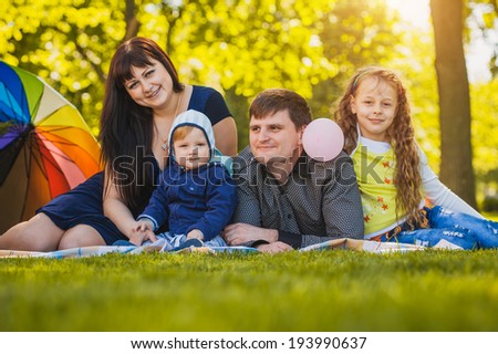 Happy family are plaing in the summer park