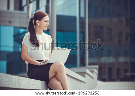 Successful businessman working at laptop. City businesswoman working.