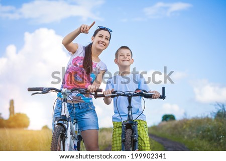 family. mother and son riding  in the park