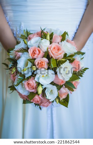 A bridal bouquet  in the the bride\'s hands
