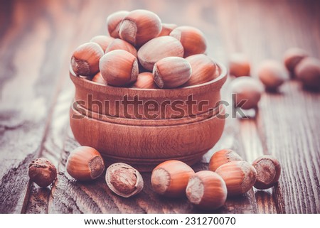 fresh hazelnuts in the shell on a wooden table